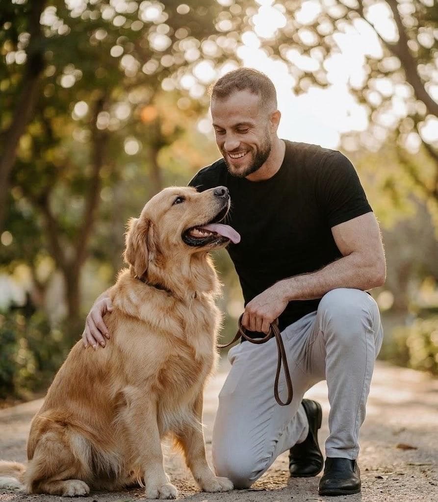 Gemini-generated photo of a man kneeling beside a golden retriever